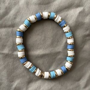 Blue, white, and gold braclet.